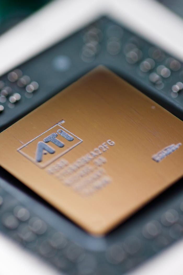 Detailed macro shot of an ATI computer processor chip, showcasing intricate electronic components.